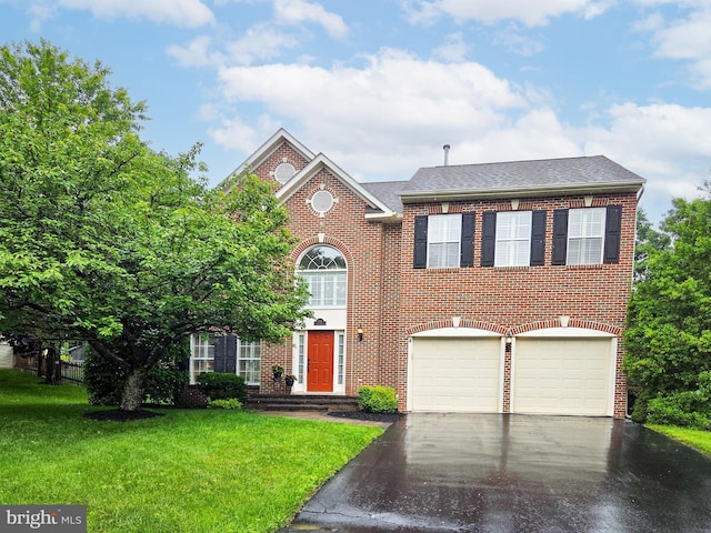 6341 Claridge Dr N, Frederick, MD 21701 - colonial inspired home with asphalt driveway, a front lawn, an attached garage, brick siding, and a shingled roof