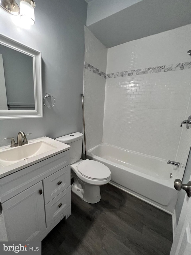 1107 N Fulton Ave, Baltimore, MD 21217 - bathroom featuring wood finished floors, vanity, and washtub / shower combination