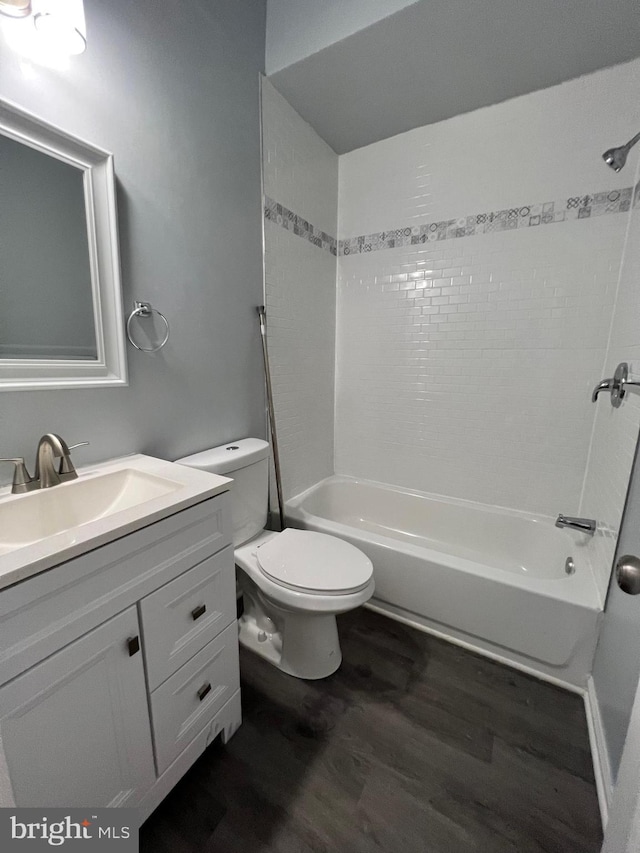 1107 N Fulton Ave, Baltimore, MD 21217 - full bath featuring wood finished floors, vanity, and shower / bath combination