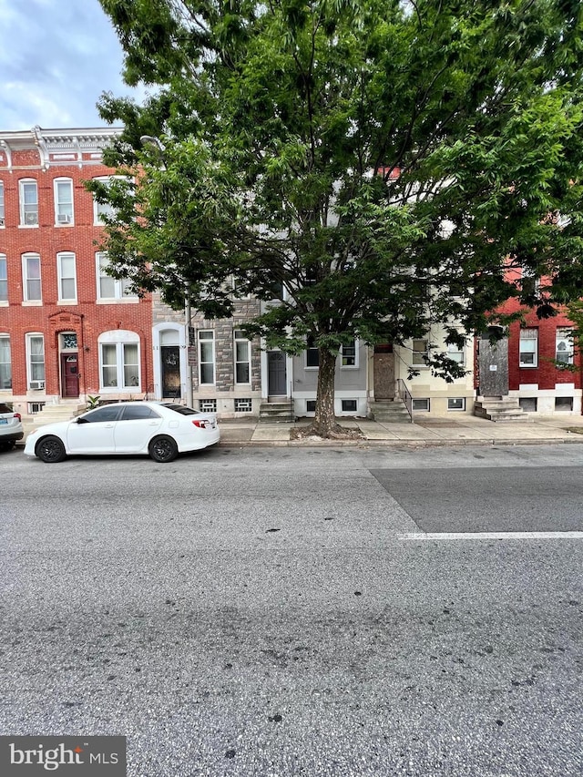 1107 N Fulton Ave, Baltimore, MD 21217 - townhome / multi-family property with entry steps and brick siding