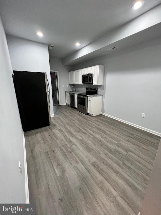 1107 N Fulton Ave, Baltimore, MD 21217 - kitchen with electric range, dishwasher, light wood-style flooring, recessed lighting, and white cabinets