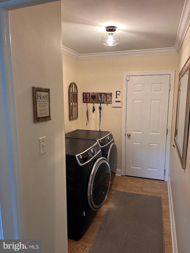 223 Country Gate Rd, Wayne, PA 19087 - laundry area featuring washer and clothes dryer, wood finished floors, and ornamental molding
