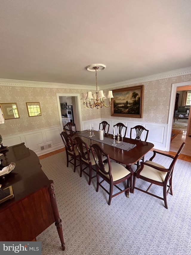 223 Country Gate Rd, Wayne, PA 19087 - dining room with wallpapered walls, ornamental molding, a wainscoted wall, and a chandelier
