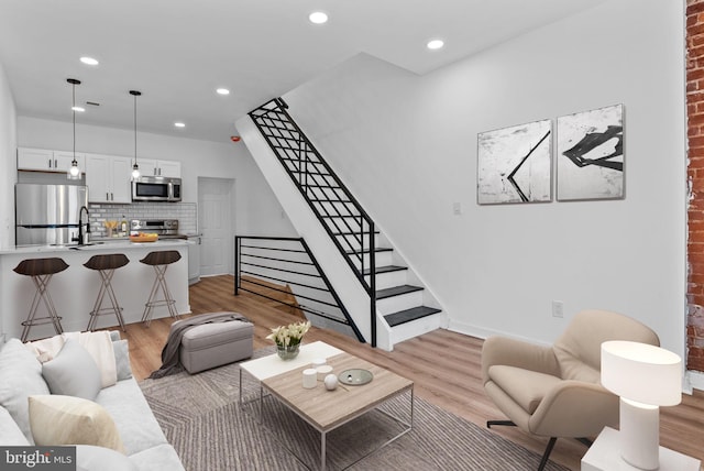 3216 N Randolph St, Philadelphia, PA 19140 - living room with light wood-style flooring, stairway, and recessed lighting