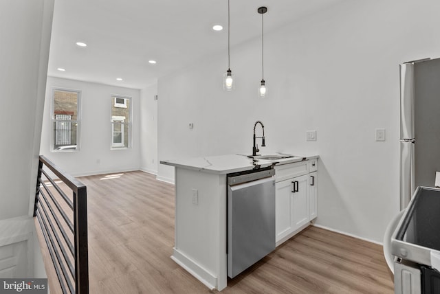 3216 N Randolph St, Philadelphia, PA 19140 - kitchen with stainless steel appliances, a peninsula, light wood-style flooring, white cabinets, and recessed lighting