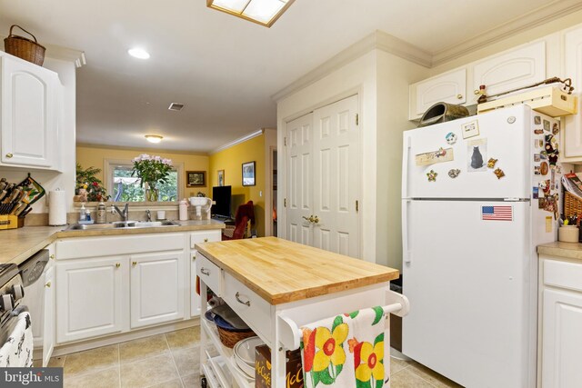 324 Winners Cir Unit 324, Red Lion, PA 17356 - kitchen featuring freestanding refrigerator, crown molding, light tile patterned floors, white cabinetry, and wooden counters