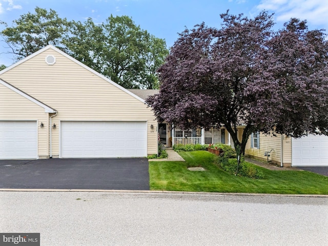 324 Winners Cir Unit 324, Red Lion, PA 17356 - view of front facade with asphalt driveway, a front yard, and a garage
