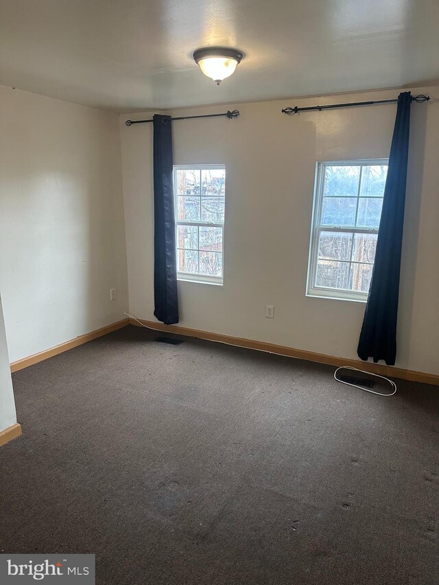 609 S Monroe St, Baltimore, MD 21223 - carpeted spare room featuring baseboards