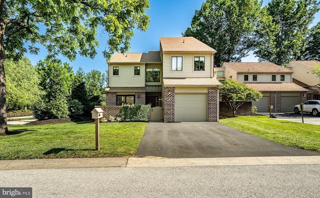 30 Scott Ct, Chesterbrook, PA 19087 - view of front facade featuring driveway, a front yard, brick siding, and a garage