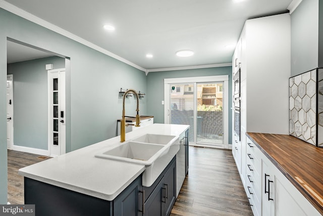 30 Scott Ct, Chesterbrook, PA 19087 - kitchen with wood counters, dark wood-style flooring, crown molding, recessed lighting, and an island with sink