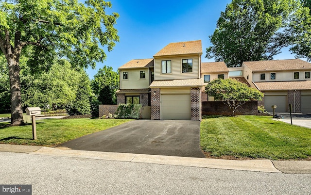 30 Scott Ct, Chesterbrook, PA 19087 - view of front of property with driveway, brick siding, a garage, and a front lawn