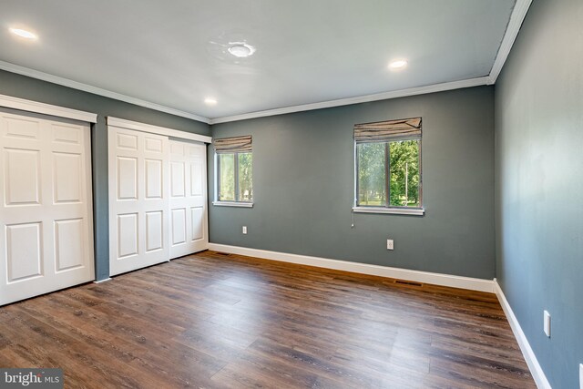 30 Scott Ct, Chesterbrook, PA 19087 - unfurnished bedroom featuring ornamental molding, multiple windows, two closets, dark wood-type flooring, and recessed lighting