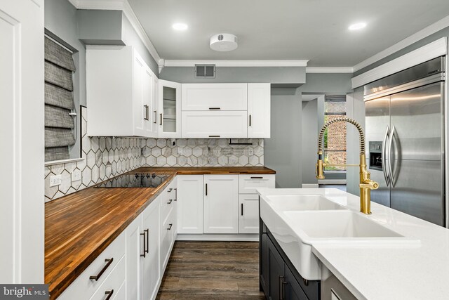 30 Scott Ct, Chesterbrook, PA 19087 - kitchen with wooden counters, built in refrigerator, black electric stovetop, dark wood-type flooring, and crown molding