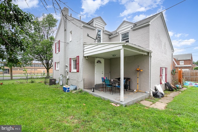 2941 N 6th St, Harrisburg, PA 17110 - back of property with brick siding, a patio, and a chimney