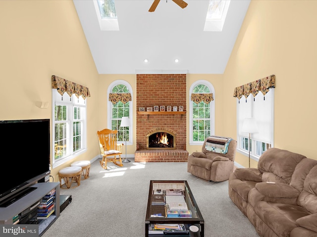 1509 Winfields Ln, Gambrills, MD 21054 - living room with a skylight, high vaulted ceiling, carpet flooring, ceiling fan, and a fireplace