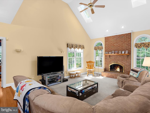 1509 Winfields Ln, Gambrills, MD 21054 - living room featuring high vaulted ceiling, a skylight, a brick fireplace, a ceiling fan, and recessed lighting