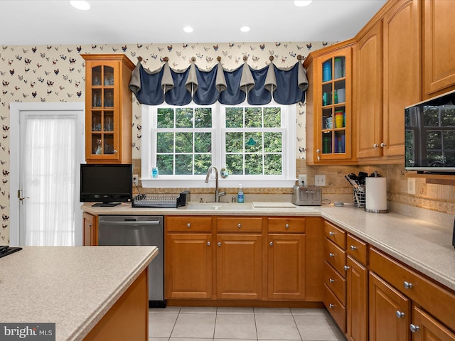 1509 Winfields Ln, Gambrills, MD 21054 - kitchen with stainless steel dishwasher, wallpapered walls, light countertops, brown cabinetry, and recessed lighting