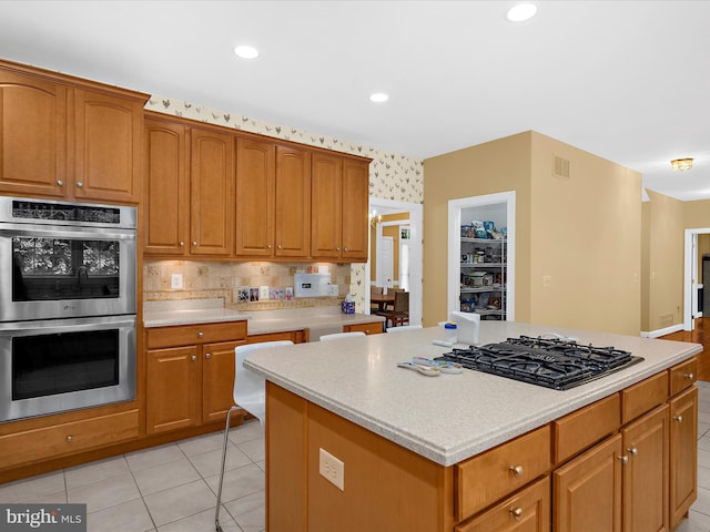 1509 Winfields Ln, Gambrills, MD 21054 - kitchen with black gas stovetop, stainless steel double oven, light countertops, light tile patterned floors, and recessed lighting