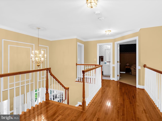 1509 Winfields Ln, Gambrills, MD 21054 - hallway featuring an upstairs landing, a chandelier, hardwood / wood-style flooring, and crown molding