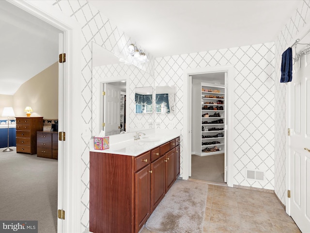 1509 Winfields Ln, Gambrills, MD 21054 - full bathroom with vanity, a spacious closet, an accent wall, and tile patterned flooring