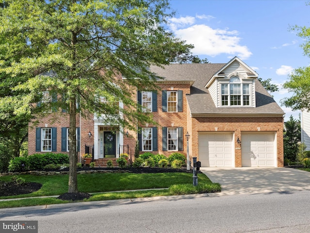 1509 Winfields Ln, Gambrills, MD 21054 - view of front facade featuring driveway, a front yard, a garage, a shingled roof, and brick siding