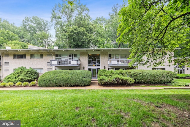 7746 Donnybrook Ct Unit 207, Annandale, VA 22003 - view of front of home featuring a balcony, brick siding, and a front yard