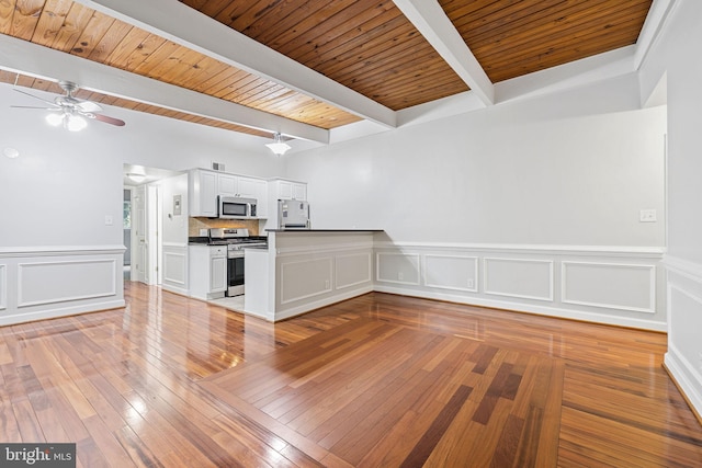 7746 Donnybrook Ct Unit 207, Annandale, VA 22003 - unfurnished living room featuring a ceiling fan, light wood-type flooring, a wood ceiling with exposed beams, wainscoting, and a decorative wall