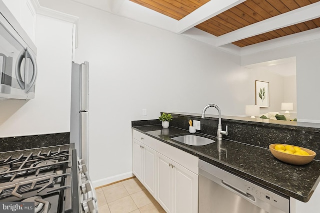 7746 Donnybrook Ct Unit 207, Annandale, VA 22003 - kitchen with appliances with stainless steel finishes, a wood ceiling with exposed beams, light tile patterned floors, dark stone counters, and white cabinets