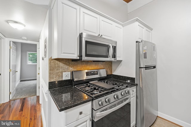 7746 Donnybrook Ct Unit 207, Annandale, VA 22003 - kitchen featuring appliances with stainless steel finishes, white cabinets, dark wood finished floors, dark stone counters, and decorative backsplash