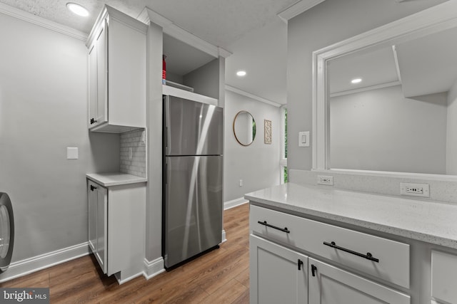 8677 Greenbelt Rd Unit 201, Greenbelt, MD 20770 - kitchen featuring freestanding refrigerator, dark wood finished floors, ornamental molding, white cabinets, and recessed lighting