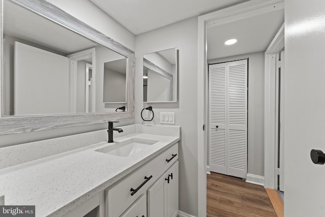 8677 Greenbelt Rd Unit 201, Greenbelt, MD 20770 - bathroom featuring vanity, wood finished floors, and recessed lighting