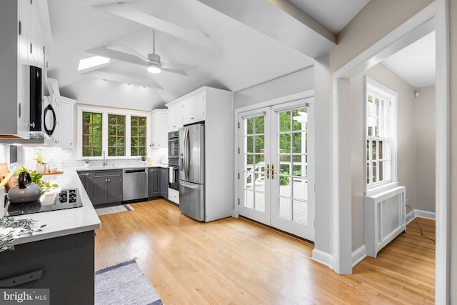 411 Windsor St, Silver Spring, MD 20910 - kitchen with appliances with stainless steel finishes, ceiling fan, light countertops, backsplash, and light wood finished floors