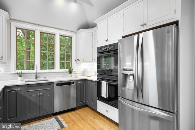 411 Windsor St, Silver Spring, MD 20910 - kitchen with stainless steel appliances, gray cabinetry, tasteful backsplash, lofted ceiling, and white cabinetry