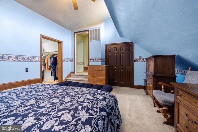 1445 Farmington Ave, Pottstown, PA 19464 - bedroom featuring vaulted ceiling, light carpet, a textured ceiling, a walk in closet, and a closet