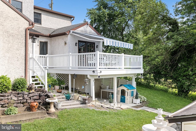 1445 Farmington Ave, Pottstown, PA 19464 - back of house with stucco siding, a patio, a wooden deck, and a lawn