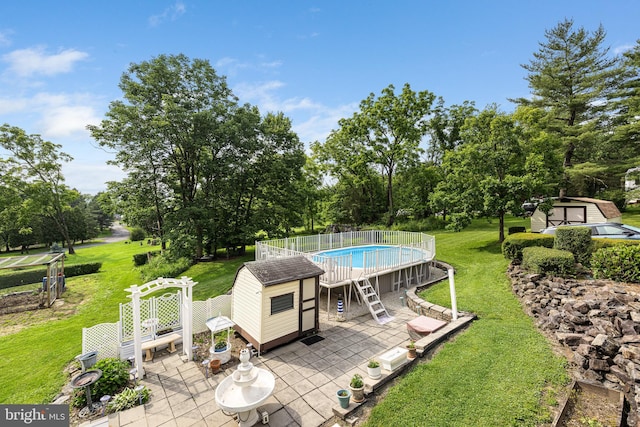 1445 Farmington Ave, Pottstown, PA 19464 - swimming pool featuring a patio, a shed, a lawn, and view of scattered trees