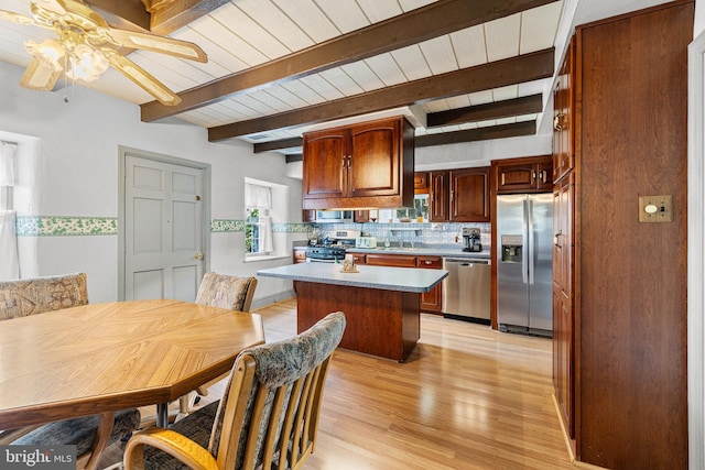 1445 Farmington Ave, Pottstown, PA 19464 - kitchen featuring stainless steel appliances, ceiling fan, decorative backsplash, light wood-style floors, and a center island