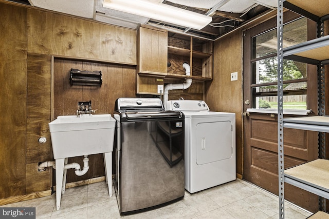 7119 Sea Cliff Rd, Mclean, VA 22101 - laundry room featuring washing machine and clothes dryer, light tile patterned floors, and wooden walls