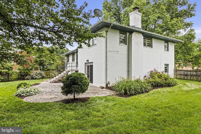 7119 Sea Cliff Rd, Mclean, VA 22101 - view of property exterior featuring brick siding, a chimney, and a patio