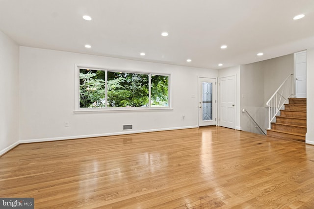 7119 Sea Cliff Rd, Mclean, VA 22101 - unfurnished living room featuring light wood-style flooring, recessed lighting, and stairs
