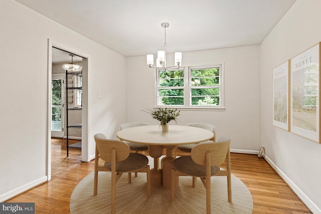 7119 Sea Cliff Rd, Mclean, VA 22101 - dining room with a chandelier and light wood-type flooring