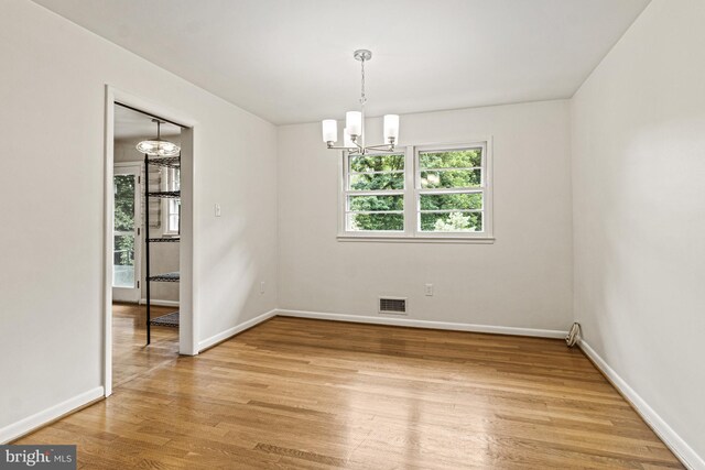 7119 Sea Cliff Rd, Mclean, VA 22101 - empty room featuring a chandelier and light wood-style flooring