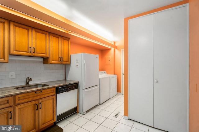 7 Stonehenge Unit 7-5, Pikesville, MD 21208 - kitchen featuring white appliances, washer and clothes dryer, brown cabinets, tasteful backsplash, and light tile patterned floors