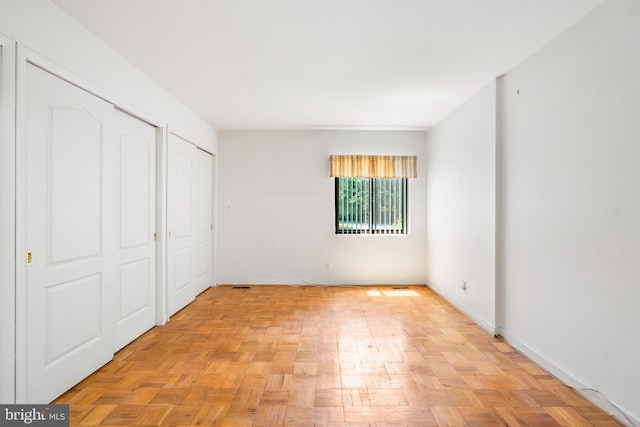 7 Stonehenge Unit 7-5, Pikesville, MD 21208 - unfurnished bedroom with baseboards and two closets
