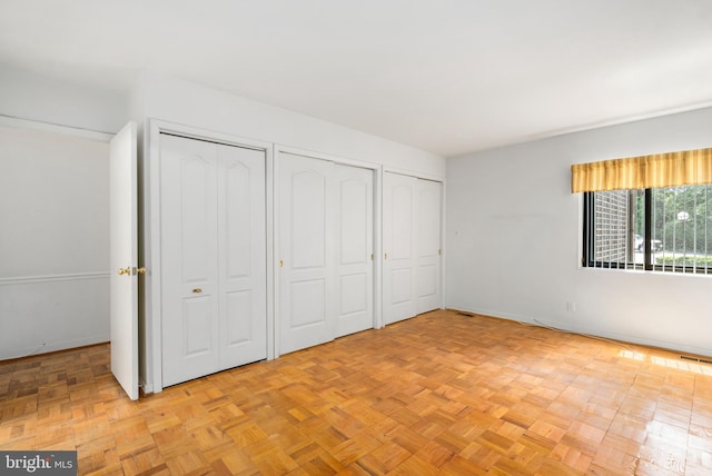 7 Stonehenge Unit 7-5, Pikesville, MD 21208 - unfurnished bedroom featuring multiple closets and baseboards