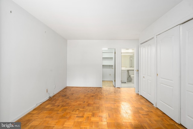 7 Stonehenge Unit 7-5, Pikesville, MD 21208 - unfurnished bedroom featuring two closets and connected bathroom