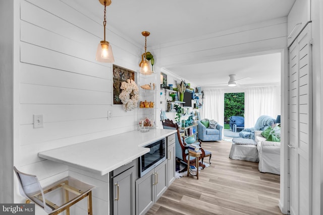 19 Warwick Way, Southampton, NJ 08088 - kitchen featuring built in microwave, open floor plan, light wood-style flooring, light countertops, and pendant lighting
