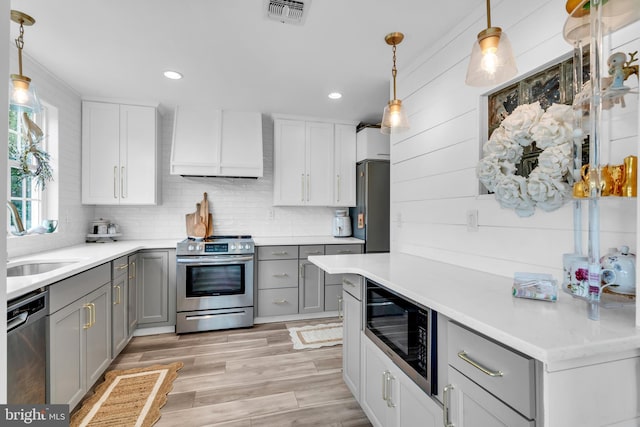 19 Warwick Way, Southampton, NJ 08088 - kitchen with stainless steel appliances, gray cabinetry, custom range hood, light countertops, and recessed lighting