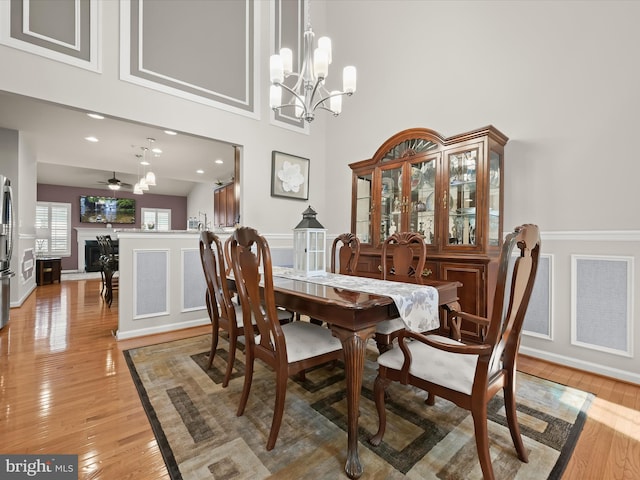 5910 Constance Way, New Market, MD 21774 - dining space featuring a chandelier, light wood-style flooring, and a towering ceiling