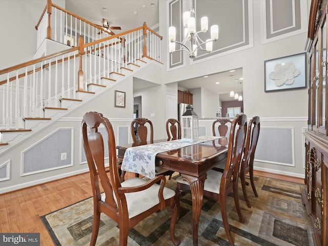 5910 Constance Way, New Market, MD 21774 - dining space with stairway, ceiling fan, wood finished floors, a chandelier, and wainscoting